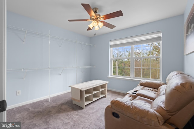 living area featuring ceiling fan and light colored carpet