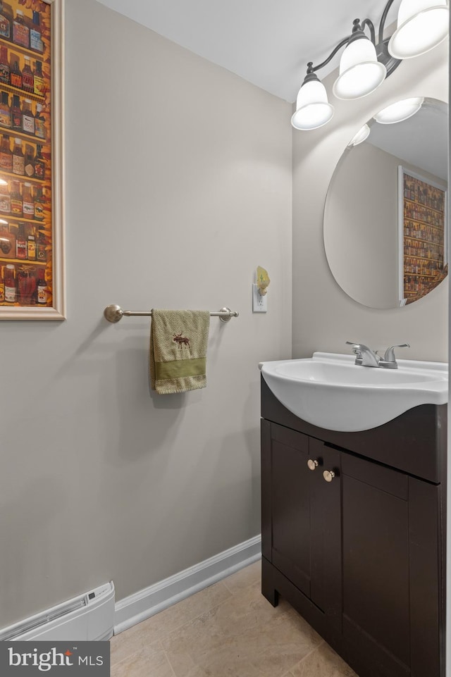 bathroom featuring tile patterned floors, vanity, and a baseboard heating unit