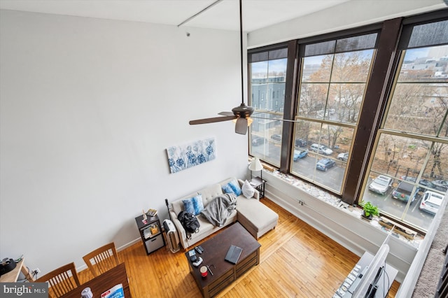 living room with hardwood / wood-style flooring and ceiling fan