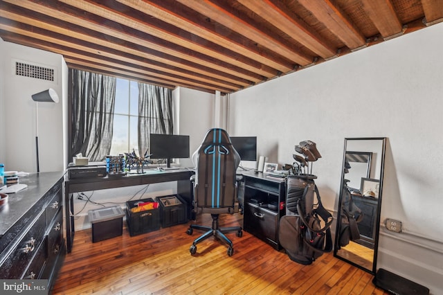 office with hardwood / wood-style floors and beamed ceiling