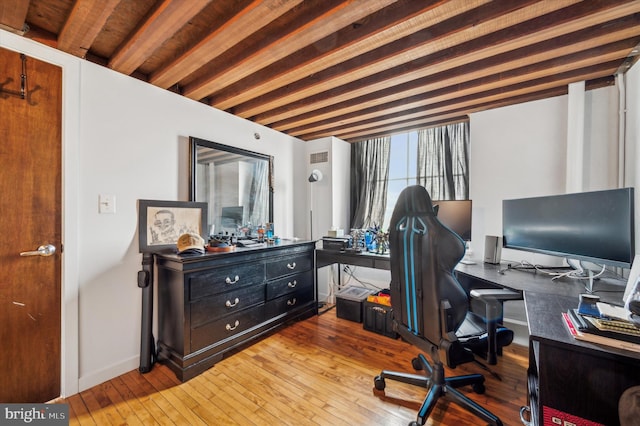 office space featuring beam ceiling and hardwood / wood-style flooring