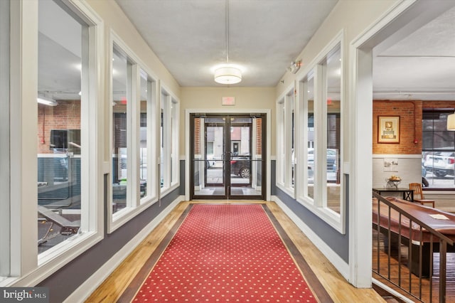 corridor featuring french doors and hardwood / wood-style flooring