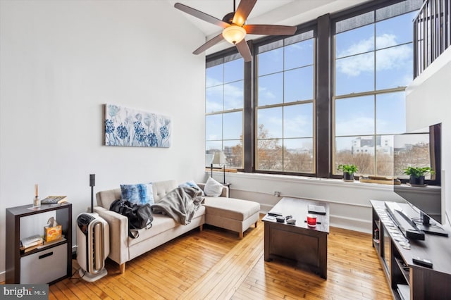 living room featuring ceiling fan and light wood-type flooring