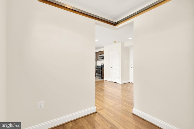 hallway with hardwood / wood-style floors and a barn door