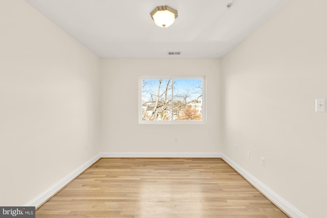 empty room with light hardwood / wood-style flooring