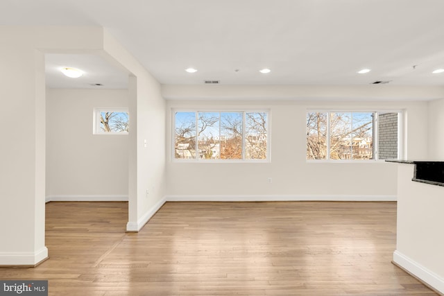 empty room with light hardwood / wood-style flooring