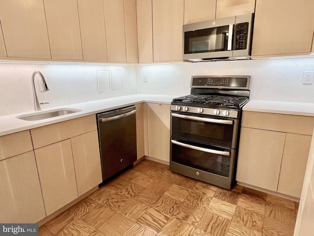 kitchen with sink, decorative backsplash, and appliances with stainless steel finishes