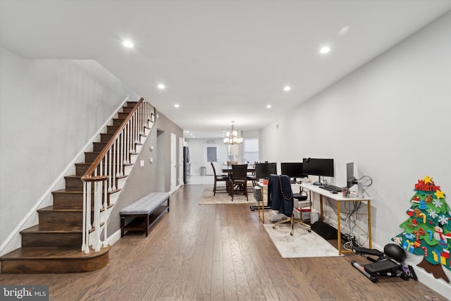 office area featuring hardwood / wood-style floors and an inviting chandelier