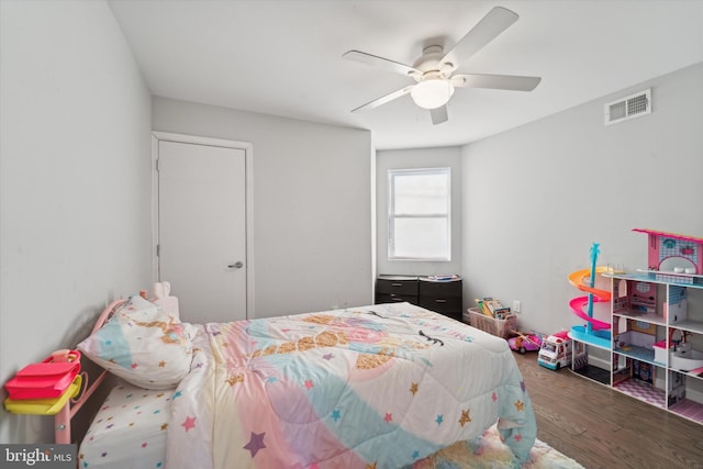 bedroom featuring ceiling fan and dark wood-type flooring