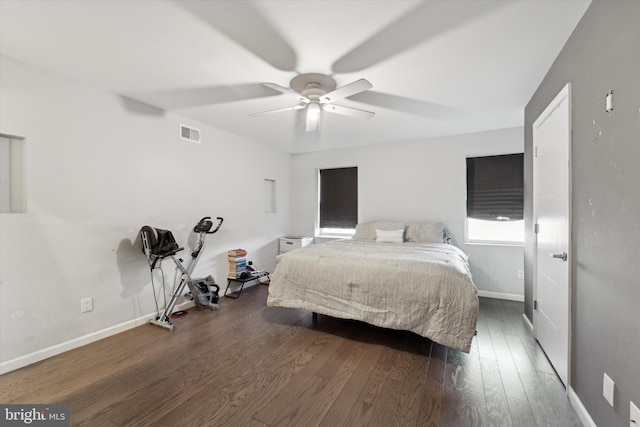 bedroom with dark hardwood / wood-style floors and ceiling fan