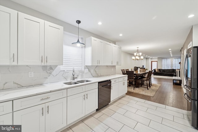 kitchen featuring stainless steel fridge, light wood-type flooring, sink, decorative light fixtures, and black dishwasher