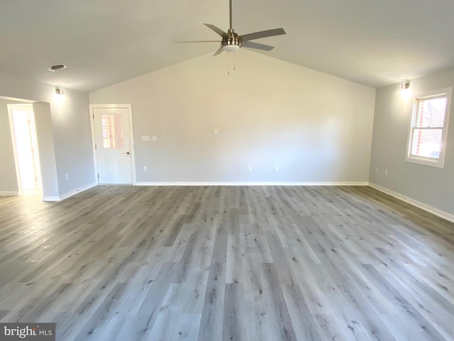 empty room featuring ceiling fan, light hardwood / wood-style floors, and vaulted ceiling