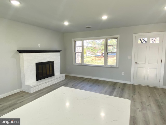 unfurnished living room with a fireplace and hardwood / wood-style floors