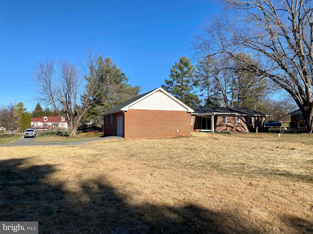 view of home's exterior with a yard