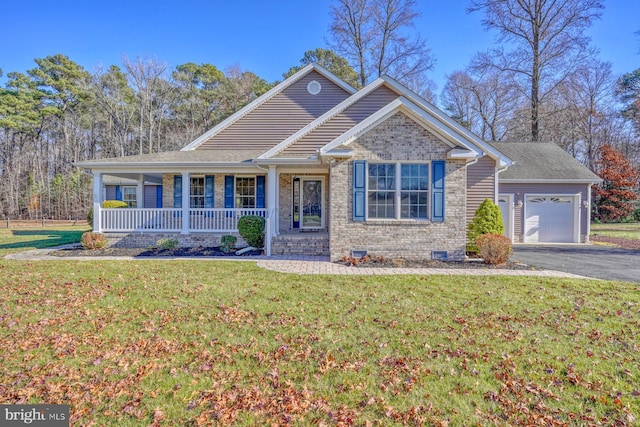 view of front of house with covered porch, a front yard, and a garage