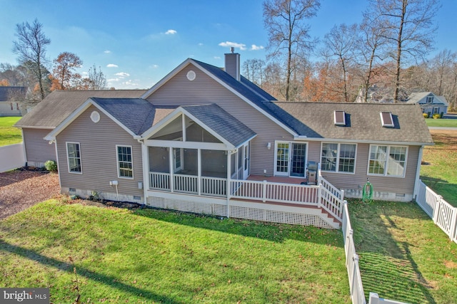 rear view of house featuring a sunroom and a yard