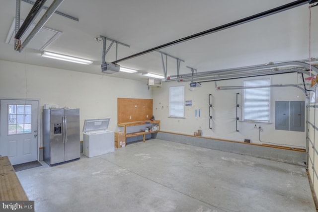 garage featuring stainless steel fridge, electric panel, and a garage door opener