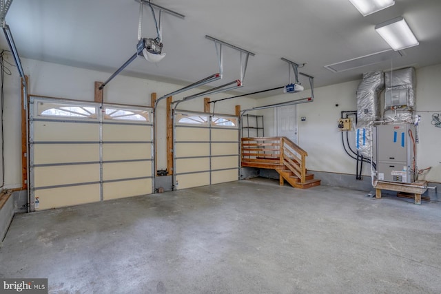 garage featuring a garage door opener and heating unit