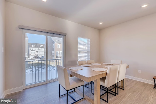 dining space with light hardwood / wood-style floors