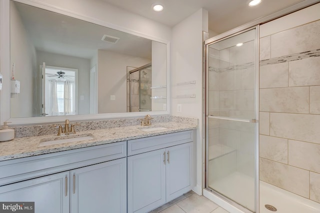 bathroom with tile patterned flooring, an enclosed shower, ceiling fan, and vanity