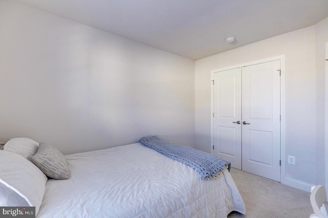 carpeted bedroom with a closet