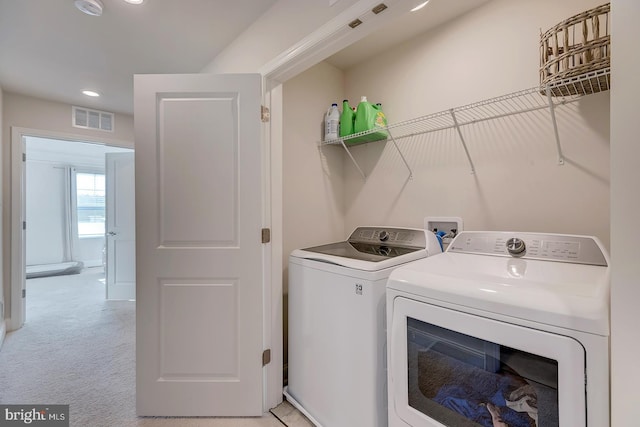 laundry area with light carpet and independent washer and dryer