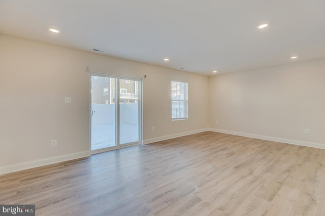 spare room with light wood-type flooring