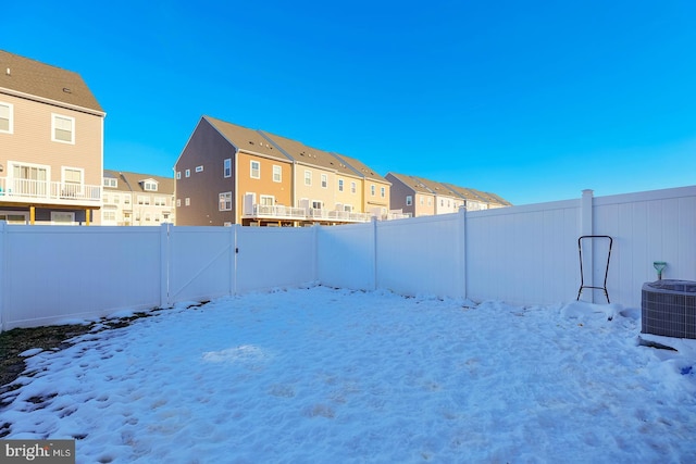 yard layered in snow featuring central AC