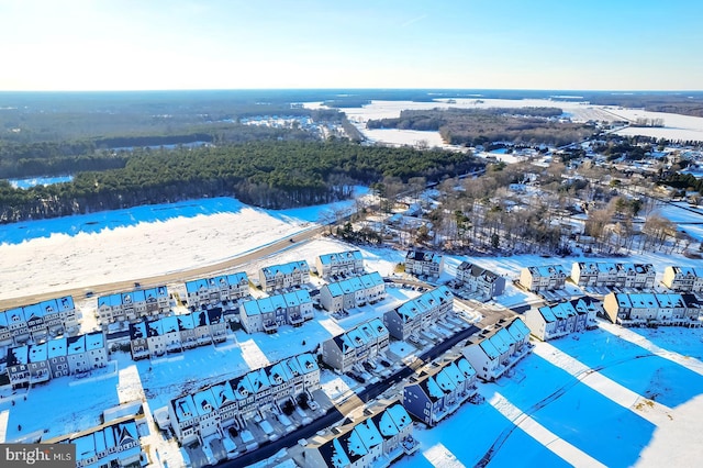 snowy aerial view with a water view