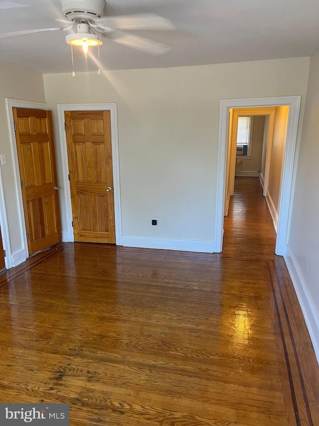 spare room featuring ceiling fan and dark hardwood / wood-style floors