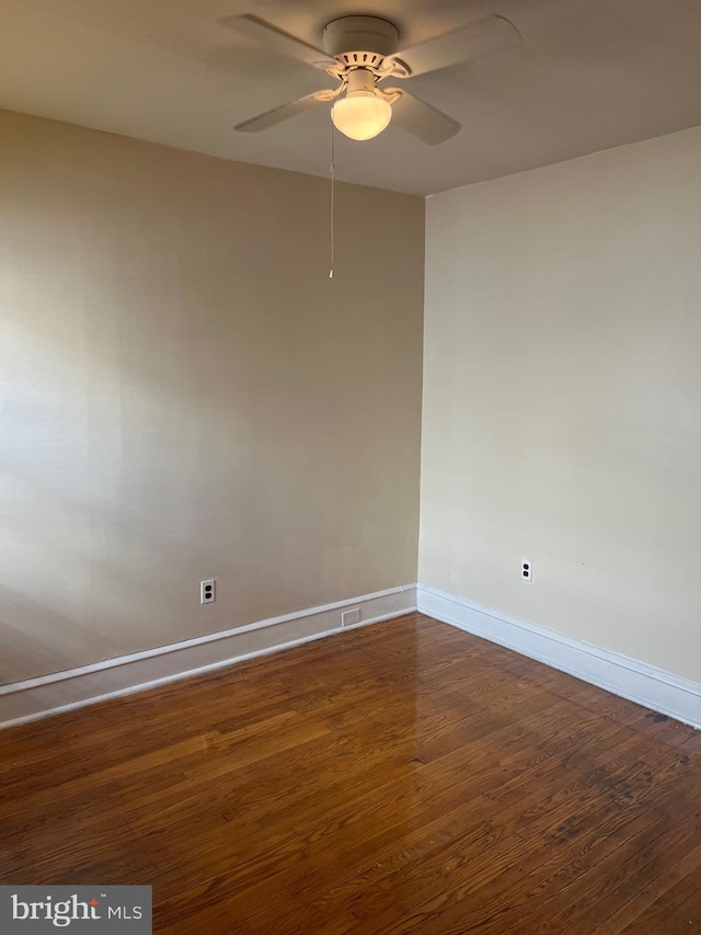 unfurnished room featuring ceiling fan and dark hardwood / wood-style flooring