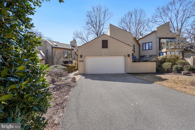 view of front of property with a garage, driveway, and stucco siding