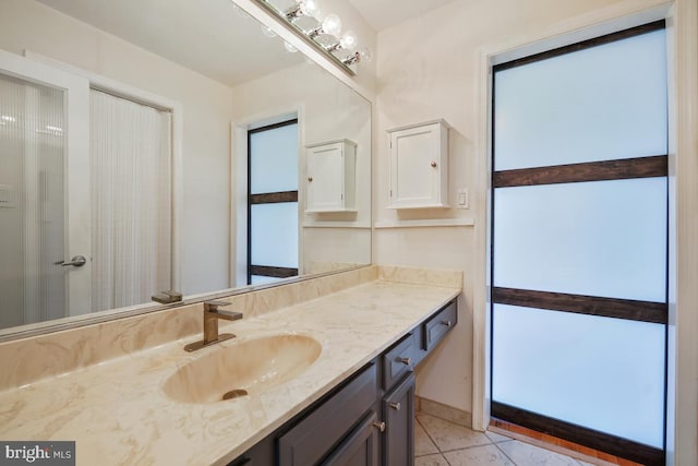 bathroom featuring tile patterned flooring and vanity