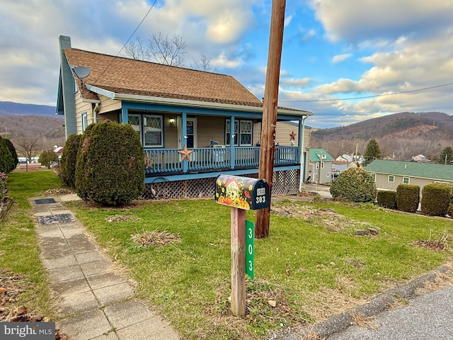 303 16th St, Saxton, PA 16678 - view of front facade featuring a mountain view, covered porch, and a front lawn