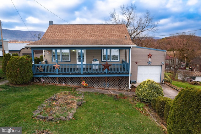303 16th St, Saxton, PA 16678 - view of front of house featuring a mountain view, a garage, covered porch, and a front yard