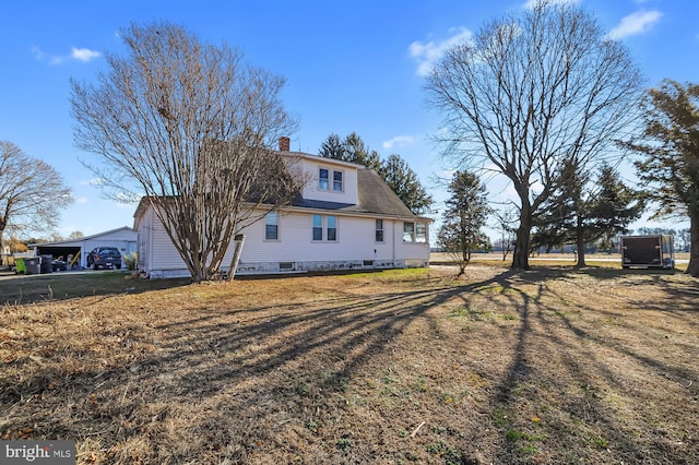 rear view of house featuring a yard