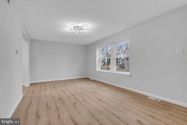 unfurnished room with light hardwood / wood-style floors