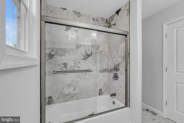 bathroom with bath / shower combo with glass door