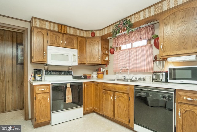 kitchen with white appliances, sink, and ornamental molding