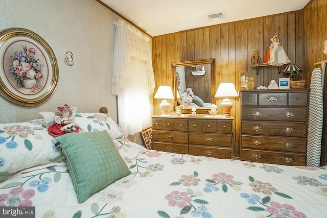 bedroom featuring wood walls, crown molding, and lofted ceiling