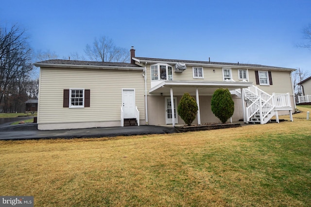 back of house with a yard