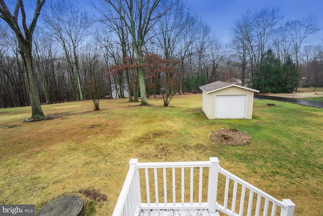 view of yard with a garage and an outdoor structure