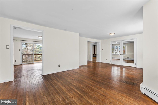 unfurnished living room featuring french doors, dark hardwood / wood-style flooring, and baseboard heating