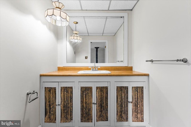 bathroom with vanity and a drop ceiling