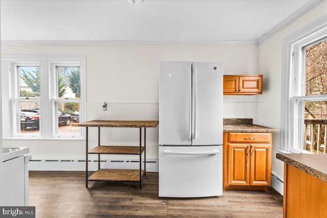 kitchen featuring ornamental molding, dark hardwood / wood-style flooring, white fridge, and a baseboard heating unit