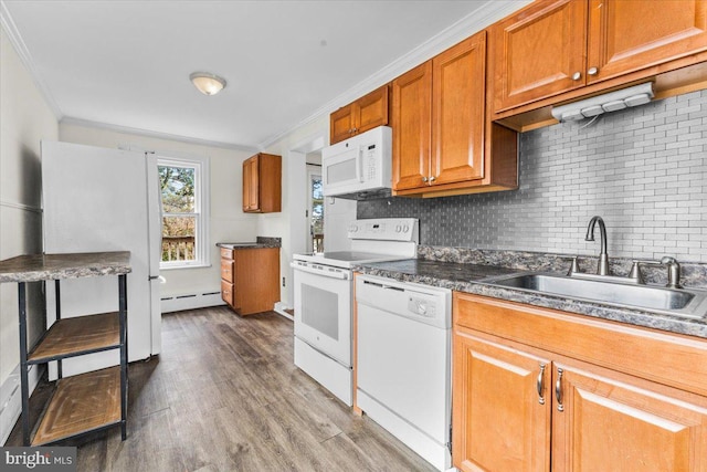 kitchen with ornamental molding, white appliances, a baseboard heating unit, sink, and wood-type flooring