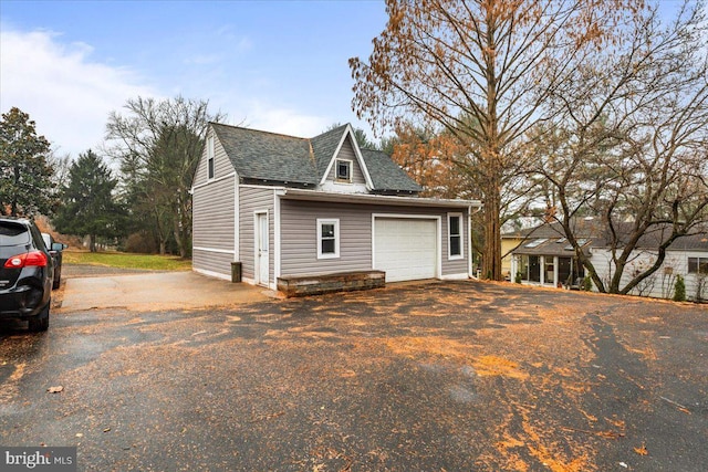 view of side of home featuring a garage