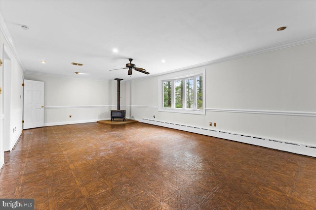 unfurnished living room featuring a wood stove, baseboard heating, crown molding, and ceiling fan