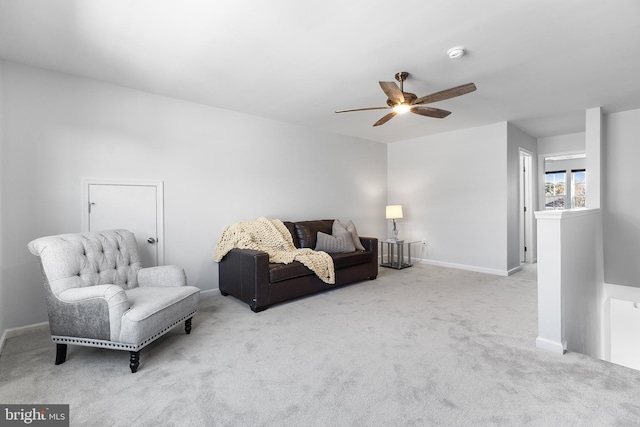 carpeted living room with ceiling fan