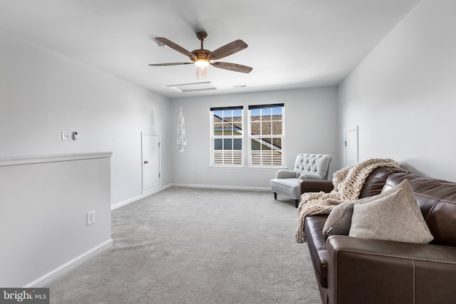 living area featuring light carpet and ceiling fan